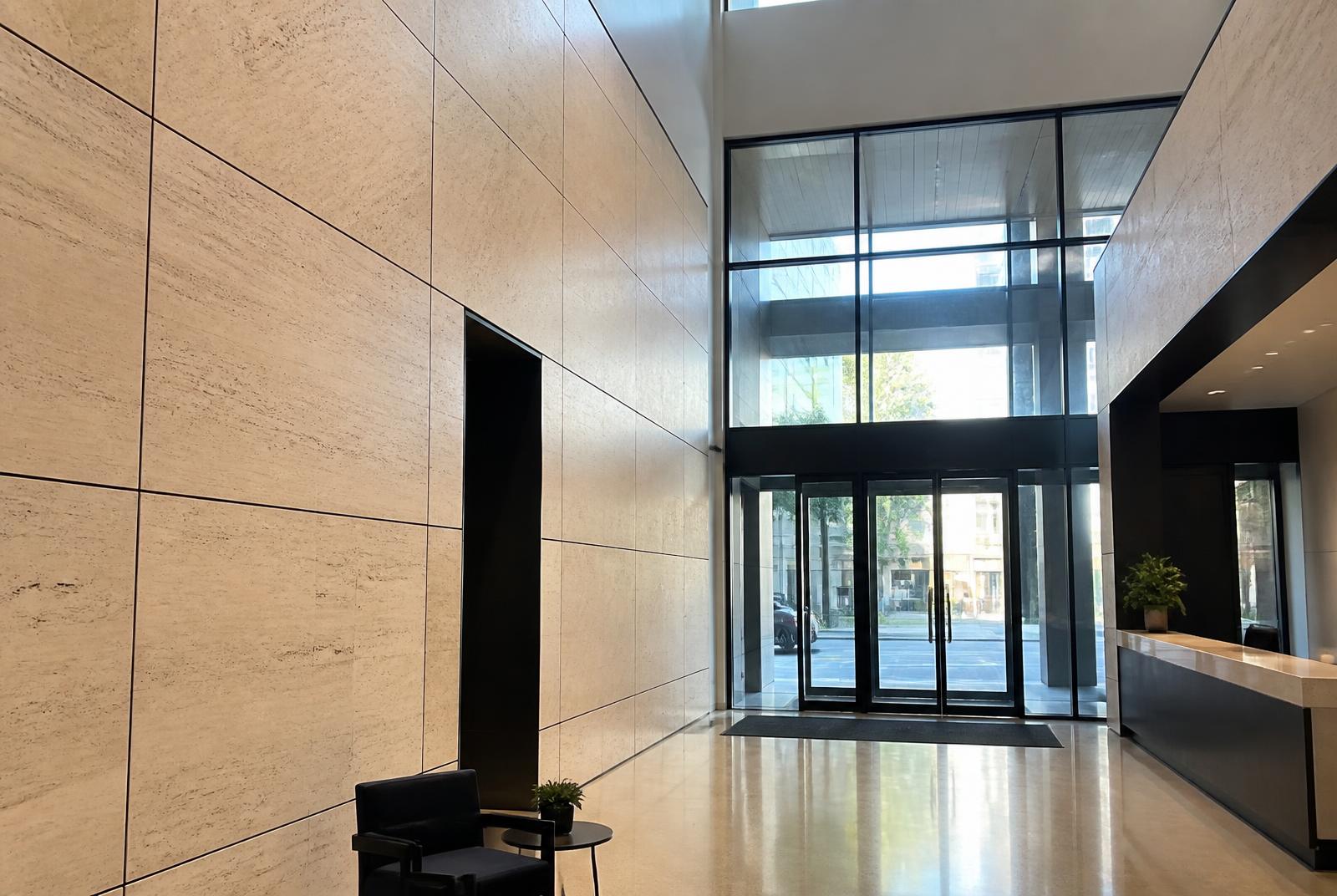 Double-height lobby clad in travertine